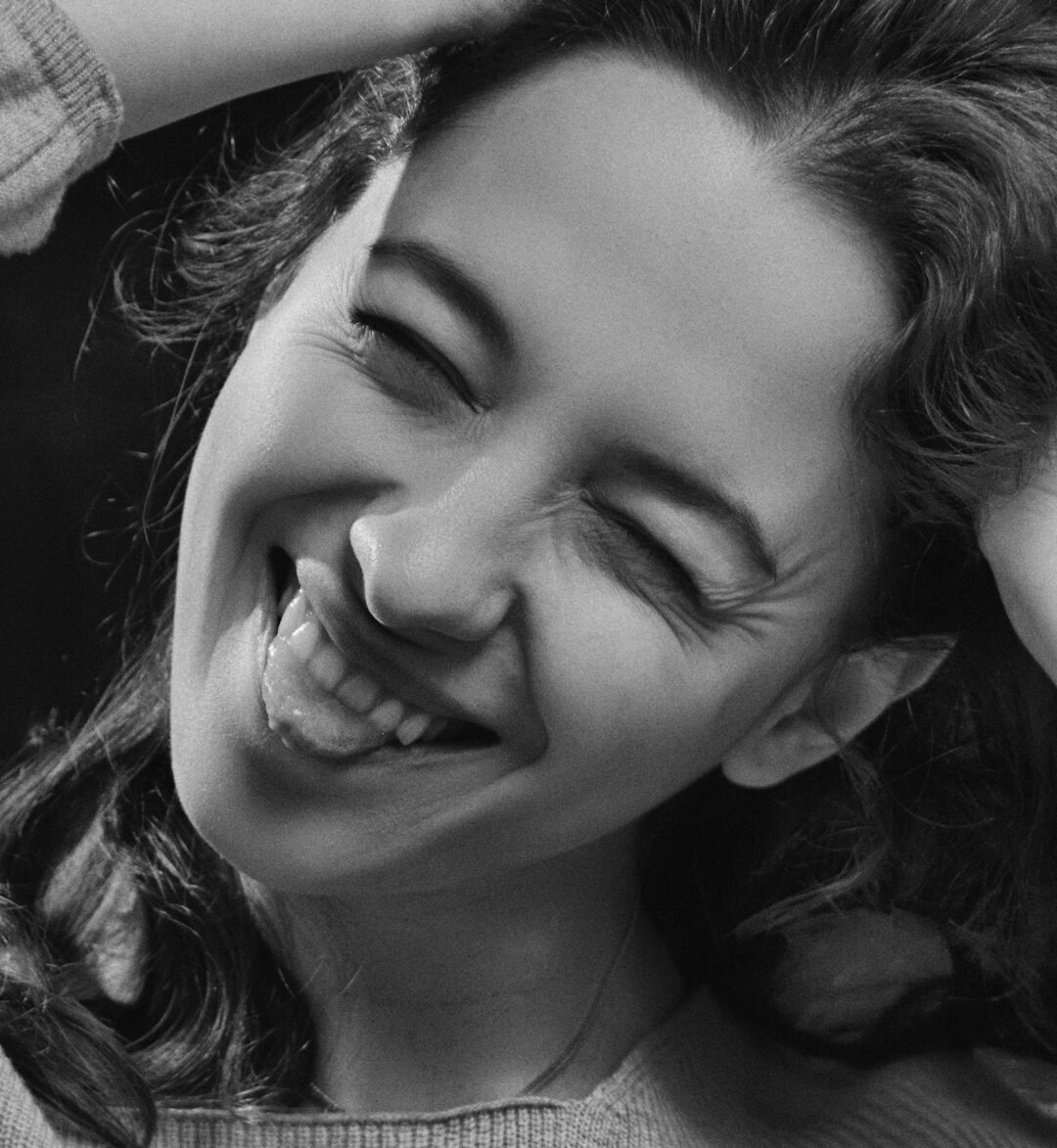 Studio portrait of a Brazilian woman with short curly hair smiling