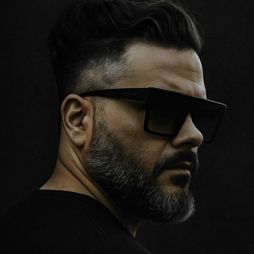 Studio portrait of a Brazilian man with glasses and a beard