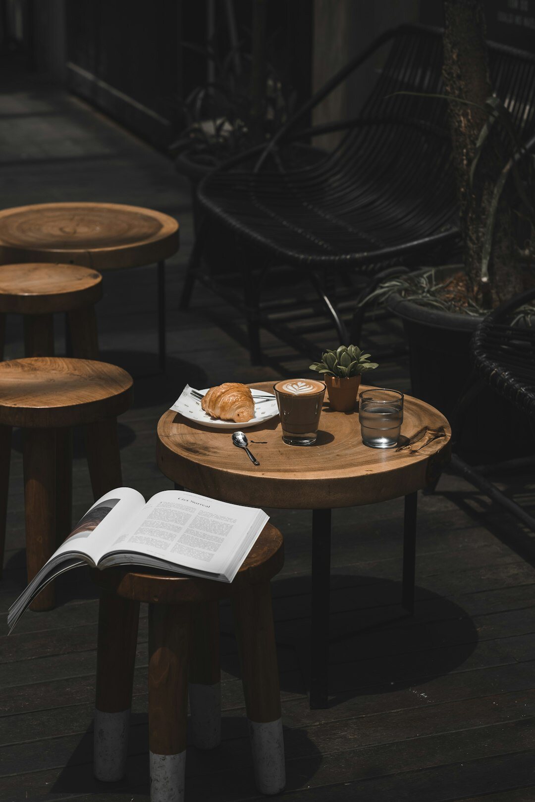 Open journal with handwriting next to a cup of coffee on a wooden table